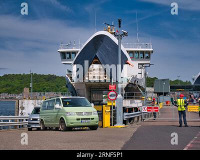 Eine grüne, irisch registrierte VW-Motorkarawane verlässt die von CalMac betriebene Roro-Autofähre Lord of the Isles in Oban, Schottland, Großbritannien. Stockfoto