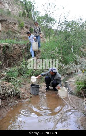 (160824) -- TONGWEI, 24. August 2016 -- Xu Zhiqiang, 68, holt Wasser aus einem Tal in der Nähe von Haus, um Bäume zu bewässern, die auf dem Berg im Dorf Zhangchuan im Tongwei County, nordwestchinesische Provinz Gansu, am 23. August 2016 gepflanzt wurden. Xu Zhiqiang und sein Zwillingsbruder Xu Zhigang haben 48 Jahre lang freiwillig Bäume auf kargen Hügeln auf dem Loess Plateau gepflanzt. Mehr als 350 mu (23 Hektar) karges Land haben sich mit ihrer Plantage von über 80.000 Bäumen und Blumen grün gemacht. Die Bemühungen der Brüder tragen nicht nur dazu bei, natürliche Schönheit zu schaffen, sondern verbessern auch die lokale ökologische Umwelt. Guo Gang) (ry) CHINA-GANSU Stockfoto