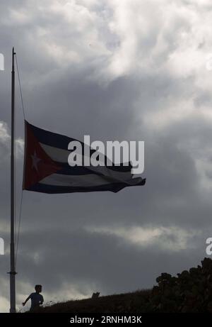 (161127) -- HAVANNA, 27. November 2016 -- Ein Junge steht unter einer kubanischen Nationalflagge am Halb-Mast zu Ehren des kubanischen Revolutionsführers Fidel Castro in Havanna, der Hauptstadt Kubas, am 27. November 2016. Die kubanische Regierung hat bis zum 4. Dezember neun Tage nationale Trauer für Fidel Castro erklärt, der am späten Freitag im Alter von 90 Jahren verstarb. KUBA-HAVANNA-FIDEL CASTRO-NATIONAL TRAUERFLAGGE-HALBMAST DavidxdexlaxPaz PUBLICATIONxNOTxINxCHN Havanna Nov 27 2016 ein Junge steht unter einer kubanischen Nationalflagge AN Halbmast ZU EHREN des kubanischen Revolutionsführers Fidel Castro in der kubanischen Hauptstadt Havanna AM 27 2016. November Stockfoto