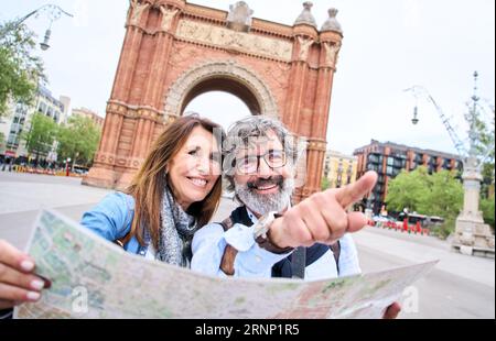 Reifes Paar aus den Sechzigern lächelt auf dem Platz der Touristenmetropole. Glückliche, liebevolle Altenehe. Stockfoto