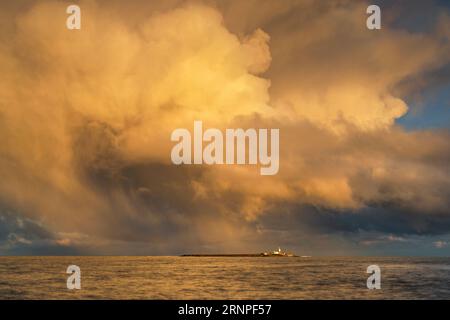 Wintersturmwolken über Coquet Island, fotografiert von Amble Harbour, Northumberland, Großbritannien Stockfoto