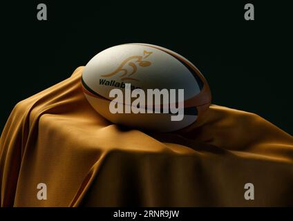 2. September 2023 - Bristol, Großbritannien: Ein 3D-Bild eines Rugby-Balls mit dem australischen Rugby-Logo auf einem drapierten gelben Stoff Stockfoto