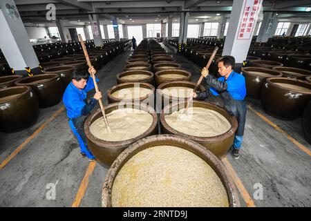 (171107) -- SHAOXING, 7. November 2017 -- Arbeiter rühren Materialien für die Herstellung von Reiswein in einer Reisweinfabrik in Shaoxing, ostchinesische Provinz Zhejiang, 7. November 2017. Mit Beginn des Winters am 7. November, einem Sonnentermin im traditionellen chinesischen Mondkalender, begann die Herstellung von Reiswein in Shaoxing City. Reiswein ist ein wichtiger Industriezweig in Shaoxing, wo 74 Reisweinunternehmen und mehr als 11.000 Arbeiter jedes Jahr mehr als 600.000 Tonnen Reiswein produzieren. Reiswein wird hier in mehr als 40 Länder und Regionen exportiert, und die Brautechnik wurde als eine der natio aufgeführt Stockfoto