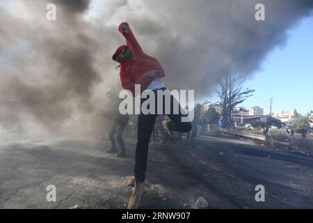 (171208) -- RAMALLAH, 8. Dezember 2017 () -- Ein palästinensischer Demonstrant schleudert Steine auf israelische Soldaten während der Zusammenstöße nach einem Protest gegen die Anerkennung Jerusalems als israelische Hauptstadt durch die USA, in der Nähe der jüdischen Siedlung Beit El, in der Nähe der Westbank-Stadt Ramallah, am 8. Dezember 2017. () MIDEAST-RAMALLAH-CLASHES Xinhua PUBLICATIONxNOTxINxCHN Stockfoto