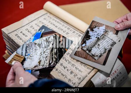 (171222) -- CHENGDU, 22. Dezember 2017 -- Yuan Dongjue zeigt Veränderungen von antiken Büchern vor und nach der Reparatur in der Sichuan Provincial Library in Chengdu, Hauptstadt der südwestchinesischen Provinz Sichuan, 21. Dezember 2017. Yuan Dongjue, ein 70-jähriger Experte für Reparaturen antiker Bücher, arbeitet seit 1983 im Ancient Books Repair Center der Sichuan Provincial Library an der Reparatur und Erhaltung antiker Bücher. In ihrer 34-jährigen Karriere hat Yuan etwa 200 wertvolle alte chinesische Bücher repariert, von denen einige bis vor 1.000 Jahren zurückreichen könnten. Die Reparaturarbeiten bestehen aus mehr als 10 verschiedenen Schritten. Auf die Repa Stockfoto