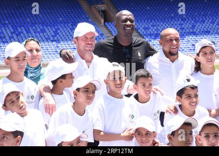 (180606) -- MARRAKESCH, 6. Juni 2018 -- ehemaliger deutscher Fußballspieler Lothar Matthaeus (4. R, Top), ehemaliger senegalesischer Fußballspieler Khalilou Fadiga (3. R, Top) und ehemaliger brasilianischer Fußballspieler Roberto Carlos (2. R, Top) posieren für Fotos mit Kindern während ihres Besuchs in einem Stadion in Marrakesch, Marokko, 5. Juni 2018. Lothar Matthaeus, Roberto Carlos und Khalilou Fadiga sind Botschafter für die WM 2026 in Marokko.) (SP)MAROKKO-MARRAKESCH-FUSSBALL-CARLOS-MATTHAEUS-FADIGA AISSA PUBLICATIONXNOTXINXCHN Stockfoto