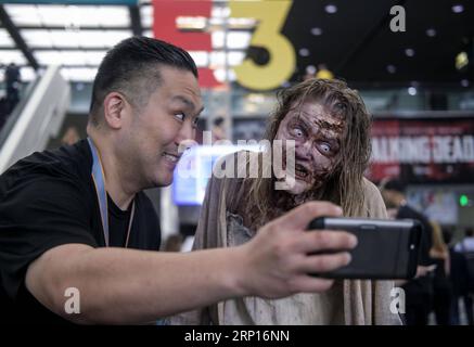 (180613) -- LOS ANGELES, 13. Juni 2018 -- Ein Besucher macht Selfie-Fotos mit einem Zombie-Cosplayer auf der Electronic Entertainment Expo 2018 (E3 2018) in Los Angeles, USA, am 12. Juni 2018.) (yy) U.S.-LOS ANGELES-E3 ZhaoxHanrong PUBLICATIONxNOTxINxCHN Stockfoto