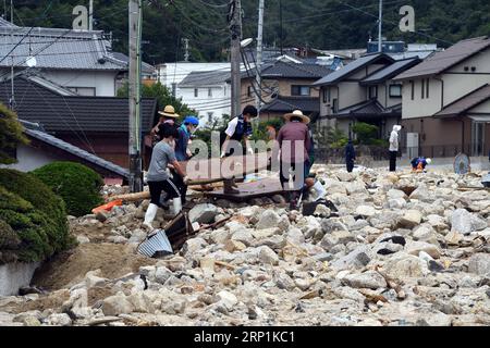 (180711) -- HIROSHIMA, 11. Juli 2018 -- Menschen räumen untergetauchte Häuser in Kure, Hiroshima, Südwest-Japan, 11. Juli 2018. Die Zahl der Todesopfer nach sintflutartigen Regenfällen, die Westjapan heimsuchten und verheerende Überschwemmungen und tödliche Erdrutsche verursachten, erreichte am Mittwoch 176, sagten die Behörden. )(yg) JAPAN-HIROSHIMA-WETTER MaxPing PUBLICATIONxNOTxINxCHN Stockfoto