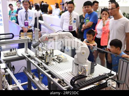 (180815) -- PEKING, 15. August 2018 -- Besucher sehen einen Industrieroboter auf der World Robot Conference 2018 in Peking, Hauptstadt Chinas, 15. August 2018. Am Mittwoch begann die Konferenz, an der Teilnehmer aus 16 Ländern und Regionen teilnahmen. ) (Hxy) CHINA-BEIJING-WORLD ROBOTER CONFERENCE-OPEN (CN) ZhangxChenlin PUBLICATIONxNOTxINxCHN Stockfoto