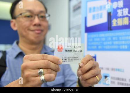 (180903) -- FUZHOU, 3. September 2018 -- Ein auf dem chinesischen Festland lebender Bewohner Taiwans zeigt die Aufenthaltserlaubnis auf der Nanjie Polizeistation der Gulou Niederlassung des Fuzhou Municipal Public Security Bureau in Fuzhou, südöstliche chinesische Provinz Fujian, 3. September 2018. Am 1. September wurde eine neue Verordnung über die Beantragung und Erteilung von Aufenthaltstiteln für Einwohner Hongkongs, Macaus und Taiwans, die auf dem chinesischen Festland leben, in Kraft gesetzt. )(LY) CHINA-FUJIAN-RESIDENCE PERMIT-HK MACAO TAIWAN RESIDENTS-ISSUING (CN) LINXSHANCHUAN PUBLICATIONXNOTXINXCHN Stockfoto