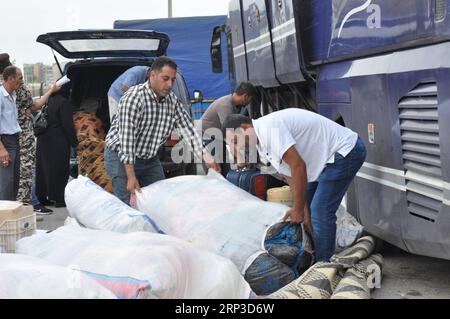 (181001) -- TRIPOLI, 1. Oktober 2018 -- syrische Flüchtlinge laden ihre Habseligkeiten in den Bus nach Syrien in Tripoli, Libanon, 1. Oktober 2018. Hunderte syrische Flüchtlinge versammelten sich am Montagmorgen, um aus dem Libanon in ihre Heimat zurückzukehren, berichteten lokale Medien. )(rh) LIBANON-TRIPOLI-FLÜCHTLING Khalid PUBLICATIONxNOTxINxCHN Stockfoto