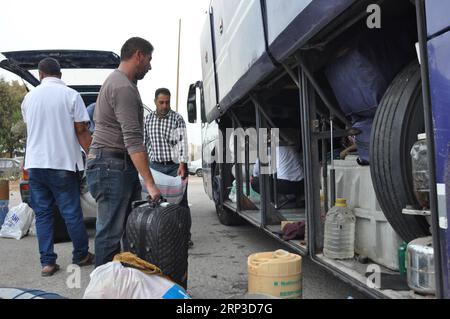 (181001) -- TRIPOLI, 1. Oktober 2018 -- syrische Flüchtlinge laden ihre Habseligkeiten in einen Bus nach Syrien in Tripoli, Libanon, 1. Oktober 2018. Hunderte syrische Flüchtlinge versammelten sich am Montagmorgen, um aus dem Libanon in ihre Heimat zurückzukehren, berichteten lokale Medien. )(rh) LIBANON-TRIPOLI-FLÜCHTLING Khalid PUBLICATIONxNOTxINxCHN Stockfoto