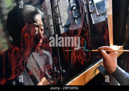 (181017) -- PINGYAO, 17. Oktober 2018 (Xinhua) -- der Handwerker Geng Baoguo legt am 16. Oktober 2018 in seiner Werkstatt in Pingyao, nordchinesische Provinz Shanxi, Farben auf ein Lack. Lacquerwares sind Objekte, die dekorativ mit Lack bedeckt sind. Die lackierten Lacke in Pingyao bestehen aus natürlichem Lack und werden mit einer speziellen Handtechnik lackiert. Nach mehreren Handwerksschritten werden sie mit verschiedenen bunten Mustern verziert und mit Ornamenten versehen. Die Oberfläche der fertigen Lacke ist glatt und glänzend. Mit einer Geschichte von über 1.000 Jahren, war das Pingyao Lackgeschirr Stockfoto