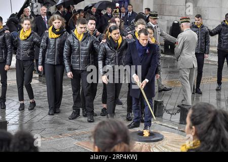 (181111) -- PARIS, 11. November 2018 -- der französische Präsident Emmanuel Macron lässt ein Feuer in der Nähe des Grabes des unbekannten Soldaten während einer Zeremonie zum hundertsten Jahrestag des Waffenstillstands des Ersten Weltkriegs in Paris, Frankreich, am 11. November 2018, wieder aufleben. ) FRANKREICH-PARIS-WWI-GEDENKEN ChenxYichen PUBLICATIONxNOTxINxCHN Stockfoto