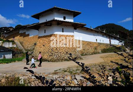 (181112) -- FUZHOU, 12. November 2018 -- Touristen besuchen den Wohnkomplex Aijing Zhuang im Dorf Yangwei im Kreis Yongtai, Provinz Fujian im Südosten Chinas, 11. November 2018. Das Projekt mit insgesamt 361 Zimmern auf einer Fläche von über 5.200 Quadratmetern wurde während der Herrschaft von Kaiser Daoguang in der Qing-Dynastie errichtet. Es hat den authentischen Charakter der traditionellen Wohnhäuser, Verteidigungsstrukturen und Wasserstraßen bewahrt, die für diese Stätte emblematisch sind und ein Modell für andere historische Dörfer in ganz China darstellen. Die Erhaltung des Wohnkomplexes Aijing Zhuang demonstriert ein Stockfoto