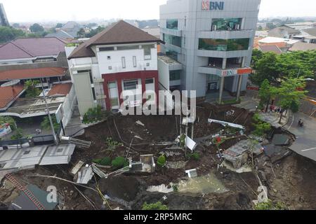 (181219) -- PEKING, 19. Dezember 2018 -- Luftaufnahme zeigt ein riesiges Sinkloch in der Mitte einer befahrenen Straße in Surabaya, Ost-Java, Indonesien, 19. Dezember 2018. Das riesige Sinkloch wurde nach Angaben eines örtlichen Beamten durch einen Baufehler verursacht. ) XINHUA FOTOS DES TAGES XINHUA FOTOS DES TAGES KURNIAWAN PUBLICATIONXNOTXINXCHN Stockfoto