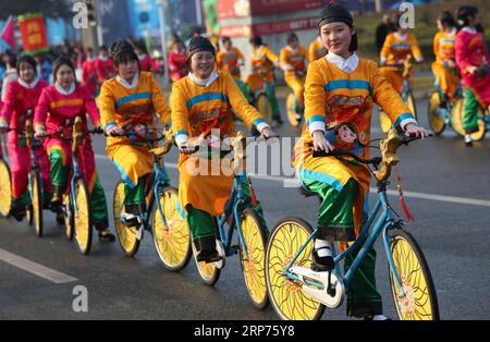 (190129) -- PEKING, 29. Januar 2019 (Xinhua) -- Menschen fahren Fahrräder in Kostümen, die von traditionellen Neujahrsbildern inspiriert sind, auf der Sumian-Straße in Mianzhu, südwestchinesische Provinz Sichuan, 28. Januar 2019. (Xinhua/Jiang Hongjing) XINHUA FOTOS DES TAGES PUBLICATIONxNOTxINxCHN Stockfoto