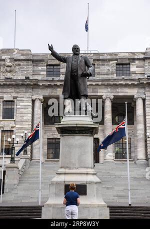 (190316) -- WELLINGTON, 16. März 2019 (Xinhua) -- Eine neuseeländische Nationalflagge fliegt am 16. März 2019 vor den parlamentsgebäuden in Wellington, der Hauptstadt Neuseelands. Bewaffnete eröffneten am Freitag das Feuer in zwei separaten Moscheen in Christchurch, wobei 49 Menschen getötet und 48 weitere verletzt wurden. (Xinhua/Guo Lei) NEW ZEALAND-WELLINGTON-CHRISTCHURCH-ATTACKS-FLAG-HALF-MAST PUBLICATIONxNOTxINxCHN Stockfoto