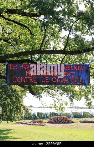 Banderoles et panneaux d’opposition à l’implation d’un Centre d’accueil de demandeurs d’asile (CADA) dans la petite commune rurale de Beyssenac e Stockfoto