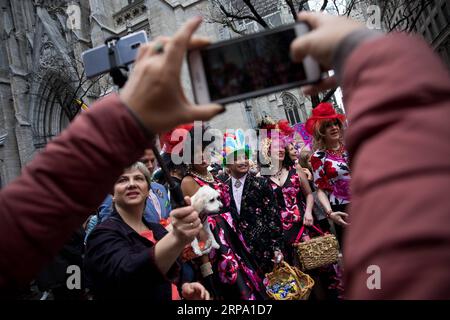 (190421) -- NEW YORK, 21. April 2019 -- die Leute machen Fotos von Feiernden mit kreativen Kostümen während der jährlichen Osterparade und des Osterbonnet Festivals in New York, USA, 21. April 2019. Erwachsene, Kinder und sogar Haustiere in kreativen bunten Hauben und Outfits nahmen am Sonntag an der jährlichen Osterparade und dem Osterbonnet Festival in New York Teil, das Tausende von Anwohnern und Touristen anzog. Der Wettbewerb ist eine New Yorker Tradition, die bis in die 1870er Jahre zurückreicht. U.S.-NEW YORK-EASTER PARADE-BONNET FESTIVAL MICHAELXNAGLE PUBLICATIONXNOTXINXCHN Stockfoto