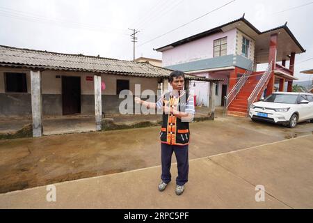 (190624) -- KUNMING, 24. Juni 2019 -- Ein Dorfbewohner stellt seine alten und neuen Häuser im Dorf Yongguang in der autonomen Grafschaft Wa von Ximeng, südwestchinesische Provinz Yunnan, 15. Juni 2019 vor. ) CHINA-YUNNAN-XIMENG-DEVELOPMENT (CN) QinxQing PUBLICATIONxNOTxINxCHN Stockfoto