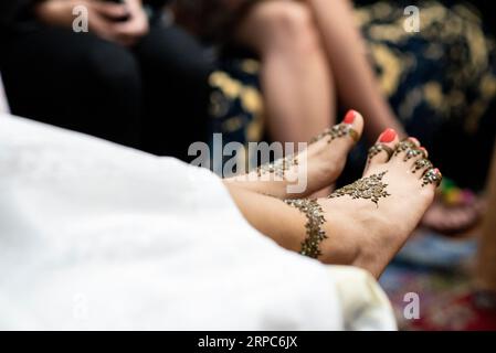 Detail der Henna-Dekoration auf Frauenfüßen während einer Feier. Stockfoto