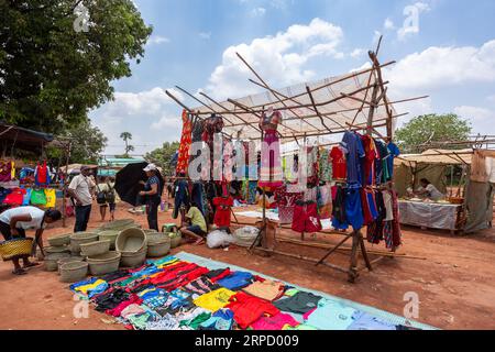 Mandoto, Madagaskar - 9. November 2022: Ein geschäftiger Straßenmarkt in Mandoto, auf dem Händler verschiedene Kleidungsarten mit lebhaften Farben verkaufen. Stockfoto