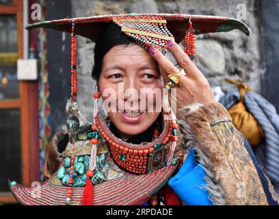 (190728) -- LHASA, 28. Juli 2019 -- Eine Frau trägt Burang Kleidung im Burang County von Ali, Südwestchinas autonome Region Tibet, 22. Juli 2019. Burang Kleidung, die traditionell in Burang County of Ali getragen wird, hat eine Geschichte von mehr als 1.000 Jahren. Ein Anzug kann etwa 25 kg wiegen, da er mit Gold, Silber, Perlen und anderen Juwelen verziert ist. ) CHINA-TIBET-ALI-BURANG CLOTHES (CN) CHOGO PUBLICATIONXNOTXINXCHN Stockfoto