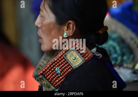 (190728) -- LHASA, 28. Juli 2019 -- Eine Frau trägt Burang Kleidung im Burang County von Ali, Südwestchinas autonome Region Tibet, 22. Juli 2019. Burang Kleidung, die traditionell in Burang County of Ali getragen wird, hat eine Geschichte von mehr als 1.000 Jahren. Ein Anzug kann etwa 25 kg wiegen, da er mit Gold, Silber, Perlen und anderen Juwelen verziert ist. ) CHINA-TIBET-ALI-BURANG CLOTHES (CN) CHOGO PUBLICATIONXNOTXINXCHN Stockfoto