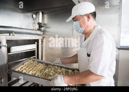 (190806) -- HUZHOU, 6. August 2019 -- Ein Mitarbeiter trägt gedämpfte Brötchen, ein traditionelles chinesisches Essen der Marke Dinglianfang, im Wuxing-Bezirk von Huzhou, ostchinesische Provinz Zhejiang, 6. August 2019. Die chinesische Marke Dinglianfang wurde in der Zeit Guangxus (1875-1908) der Qing-Dynastie gegründet. Sie hat eine Reihe von unverwechselbaren Lebensmitteln entwickelt und sich auch auf dem Online-Markt engagiert. ) CHINA-ZHEJIANG-HUZHOU-DINGLIANFANG-TIME-HONORED BRAND (CN) WENGXXINYANG PUBLICATIONXNOTXINXCHN Stockfoto