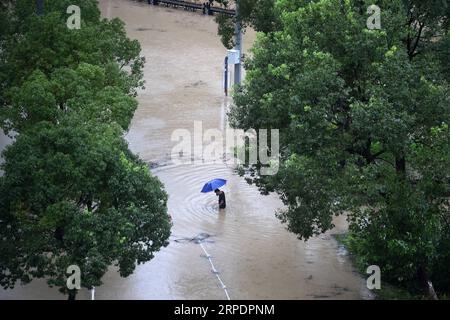 News Bilder des Tages (190810) -- WENLING, 10. Aug. 2019 -- Ein Mann wadet über eine wasserdurchflutete Straße in Wenling, ostchinesische Provinz Zhejiang, 10. Aug. 2019. Gegen 1:45 Uhr landete das Zentrum von Taifun Lekima, dem neunten Taifun des Jahres, in der Stadt Wenling in Zhejiang mit einer maximalen Windkraft von 187 km/h. Mehr als eine Million Menschen wurden umgesiedelt, bevor der Taifun Lekima in Wenling City landete. Der Supertyphoon schwächte sich um 5 Uhr morgens bei einer maximalen Windkraft von 144 km/h zu einem Taifun ab. CHINA-ZHEJIANG-WENLING-TYPHOON LEKIMA (CN) HANXCHUANHAO PUBLICATIONXNOTXINXCHN Stockfoto