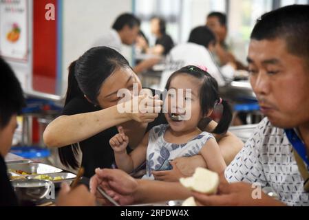 (190812) -- SHOUGUANG, 12. August 2019 -- Menschen essen in einer Mittelschule, die heute als Umzugsort dient, in Shouguang, Ostchinas Provinz Shandong, 12. August 2019. Etwa 93.000 Einwohner wurden umgesiedelt, da der Taifun Lekima in Teilen von Shouguang verheerende Schäden angerichtet hat. CHINA-SHANDONG-TYPHOON-LEKIMA-RELOCATION (CN) WANGXKAI PUBLICATIONXNOTXINXCHN Stockfoto