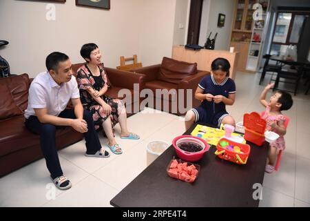 (190818) -- CHANGSHA, 18. August 2019 -- Xiao Yangbao (1. L) beobachtet seine Töchter zu Hause in Changsha, Hauptstadt der zentralchinesischen Provinz Hunan, 15. August 2019. Zurück aus dem Krankenhaus, Xiao, als Arzt für Infektionskrankheiten Behandlung, kommt in der Regel nicht in die Nähe seiner kleinen Tochter vor dem Bad. Xiao Yangbao, ein 39-jähriger Arzt im Endoskopiezentrum des Hunan Chest Hospital, arbeitet seit fast 8 Jahren an der Prävention und Behandlung von Tuberkulose. Als Arzt, der endoskopische Operationen durchführt, ist Xiao einem höheren Risiko für Tuberkulose und einer höheren Operation ausgesetzt Stockfoto