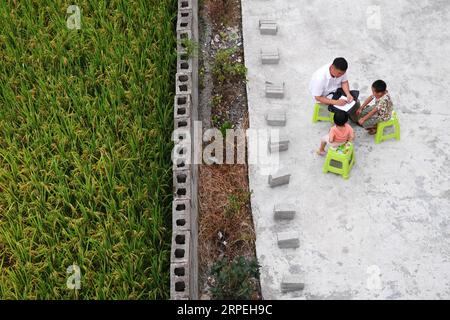 (190829) -- GUIYANG, 29. August 2019 -- Wu Guoxian unterrichtet Studenten während eines Hausbesuchs im Dorf Liuguang im Kreis Longli in der autonomen Präfektur Bouyei-Miao von Qiannan, Provinz Guizhou im Südwesten Chinas, 26. August 2019. Die Gugang Primary School im Dorf Liuguang liegt tief in den Bergen und begrüßte sechs Vorschulkinder und vier Erstklässler, als das neue Semester am Montag begann. Sie werden von Wu Guoxian unterrichtet, dem einzigen Schullehrer hier. Wu, 53, arbeitet seit 36 Jahren an der Schule, seit er 1983 an einer Junior High School abschloss. Die Schule hatte einen heruntergekommenen Lehrerbau Stockfoto