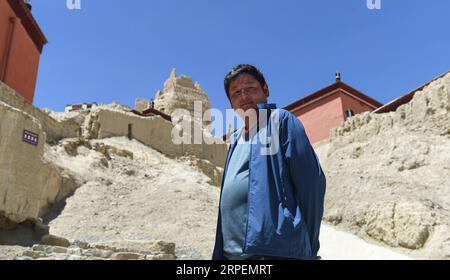 (190901) -- NGARI, 1. Sept. 2019 (Xinhua) -- Basang Cering steht an den Reliquien des Königreichs Guge in der Präfektur Zanda County of Ngari, der autonomen Region Tibet im Südwesten Chinas, 30. Juli 2019. Jedes Jahr besuchen etwa 100.000 Menschen die Ruinen eines geheimnisvollen antiken Königreichs im Westen Tibets. Die meisten sind Touristen, die kurz durchfahren, aber nicht Basang Cering. Der 30-jährige Mann bewahrt seit 2013 die Reliquien des Königreichs Guge im Zanda County, Präfektur Ngari, der autonomen Region Tibet im Südwesten Chinas. Er studierte eine traditionelle tibetanische Maltechnik namens Thangka an der Tibet University, und Stockfoto