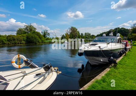 Freizeitboote legten am Fluss Yare in Bramerton Common in den Norfolk Broads England an. Stockfoto