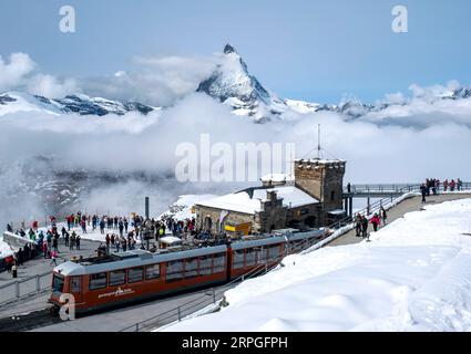 Die Gornergrat Bahn Zahnradbahn erreicht den Gornergrat Bahnhof mit dem Matterhorn in der Ferne, Kanton Wallis, Schweiz Stockfoto