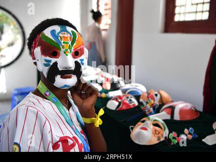 191030 -- ZHENGZHOU, 30. Oktober 2019 -- Raissa versucht Facial Make-up Flan Painting an der SIAS Universität in Zhengzhou, zentralchinesische Provinz Henan, 28. Oktober 2019. Die 17-jährige Raissa wurde auf den Komoren geboren und wuchs auf, einem Inselstaat im Indischen Ozean. 2016 wurde Raissas Großmutter von Ärzten des chinesischen Ärzteteams in Afrika geheilt. Raissa entwickelte daraufhin eine starke emotionale Verbindung zu China, was sie dazu veranlasste, Chinesisch am örtlichen Konfuzius-Institut mit unermüdlichen Bemühungen zu lernen. Zum Vorwettbewerb des 12. Chinesischen Brückenkompetenzwettbewerbs für den Sekundarbereich Stockfoto