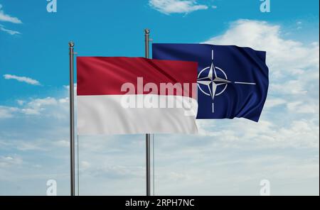 NATO-Flagge und indonesische und Bali-Inselflagge, die am blauen Himmel zusammenwinken Stockfoto