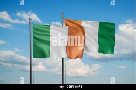Elfenbeinküste oder Ivoirküste und Irland Flagge, die im Wind am blauen Himmel zusammen winken, zwei Länderkooperationskonzept Stockfoto