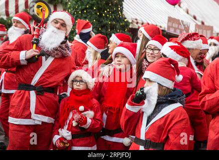 191208 -- LETTLAND, 8. Dezember 2019 -- Menschen in Weihnachtsmannkostümen nehmen am 12. Weihnachtsmannlauf in Riga, Lettland, am 8. Dezember 2019 Teil. Hunderte von Menschen nahmen am Sonntag an der jährlichen Wohltätigkeitsveranstaltung Teil. Foto von /Xinhua LETTLAND-RIGA-SANTA S FUN RUN EdijsxPalens PUBLICATIONxNOTxINxCHN Stockfoto