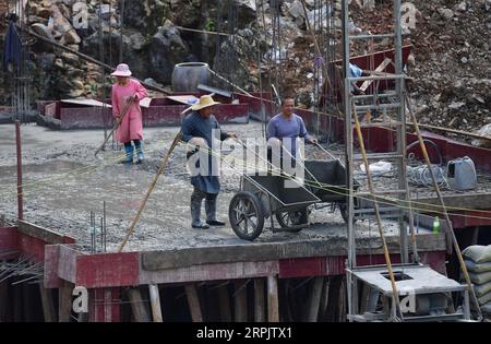 191220 -- DAHUA, 20. Dezember 2019 -- Menschen renovieren alte Häuser im Dorf Bahao im Autonomen Kreis Dahua Yao, südchinesische Autonome Region Guangxi Zhuang, 12. November 2019. Dahua ist von steiniger Wüstenbildung heimgesucht und gehört zu den am stärksten von Armut betroffenen Bezirken in Guangxi, wobei 90 % der Fläche mit Steinen bedeckt sind. Die Menschen hier lebten früher in traditionellen Häusern mit drei Stockwerken, in denen die erste Etage für die Viehzucht, die zweite für den Aufenthalt und die dritte für die Lagerung von Lebensmitteln verwendet wird. Da die meisten Häuser mit Reetdach oder Holzfliesen ausgestattet sind, müssen die Menschen beim Brandschutz sehr vorsichtig sein. Auf einem han Stockfoto