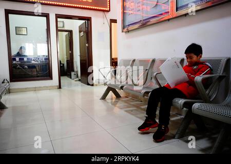 200121 -- SHIJIAZHUANG, 21. Januar 2020 -- Zhang Anzhe wartet, bis sein Vater seine Arbeit auf einer lokalen Polizeiwache in Shijiazhuang, nordchinesische Provinz Hebei, am 21. Januar 2020 verlässt. Das Frühlingsfest ist die größte Gelegenheit für Familientreffen in ganz China, aber für die Familie des 6-jährigen Zhang Anzhe sind Wiedervereinigungsmöglichkeiten selten. Zhangs Vater Zhang Peng ist Polizist und arbeitet im Polizeibüro des Bahnhofs Shijiazhuang, während seine Mutter Li Qi Chefdirigent in den Zügen zwischen Shijiazhuang und Wuhan ist. Beide Eltern waren während der Frühjahrsfest-Reisereisezeit so beschäftigt. Sie haben es Stockfoto