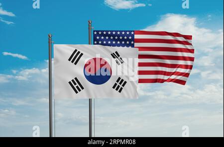 Die Flagge der USA und Südkoreas weht im Wind am blauen Himmel zusammen, zwei Konzepte der Länderzusammenarbeit Stockfoto