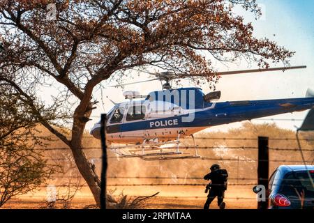 Polizeihubschrauber landen am Boden, Spezialkräfte SWAT mit einem Durchsuchungsbefehl kämpfen einen Krieg gegen Drogen Stockfoto