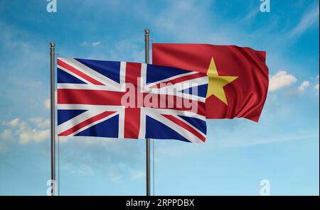 Vietnam und Vereinigtes Königreich, Großbritannien, Großbritannien Flagge winkt zusammen im Wind am blauen Himmel Stockfoto