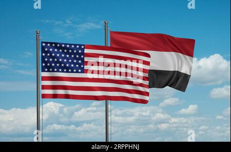 Die Flagge des Jemen und der USA weht im Wind am blauen Himmel zusammen, zwei Konzepte der Länderzusammenarbeit Stockfoto