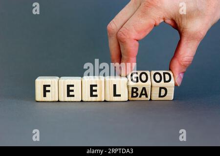 Symbol für gutes oder schlechtes Gefühl. Geschäftsmann dreht Holzwürfel und ändert das Wort, fühlt sich schlecht an, um gut zu fallen. Schöner grauer Tischgrauer Hintergrund. Business Feel Go Stockfoto