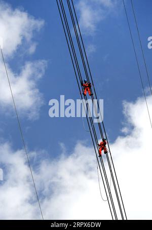 200510 -- PEKING, 10. Mai 2020 -- Arbeiter installieren Freileitungen für ein 800-kV-Gleichstromübertragungsprojekt, das die nordwestchinesische Provinz Qinghai und die zentralchinesische Provinz Henan in der Provinz Shaanxi im Landkreis Zhen an der nordwestchinesischen Provinz Shaanxi am 8. Mai 2020 verbindet. XINHUA-FOTOS DES TAGES TaoxMing PUBLICATIONxNOTxINxCHN Stockfoto