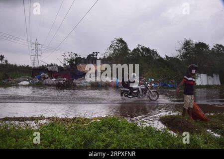 200521 -- KOLKATA, 21. Mai 2020 -- Pendler reisen durch wassergesäumte Straßen, nachdem der schwere Zyklonsturm Amphan Kolkata, Indien, am 21. Mai 2020 getroffen hatte. Mamata Banerjee, die Ministerin des indischen Oststaates Westbengalen, sagte am Donnerstag, dass in ihrem Bundesstaat 72 Menschen durch den schweren Zyklonsturm Amphan getötet wurden. Der Zyklonsturm, der böige Winde bis zu 190 km/h auslöste und Regen erschütterte am Mittwochabend West-Bengalen und die Küste von Odisha, flachte provisorische Häuser ab und raubte Elektromasten und Bäume. STR/Xinhua INDIA-KOLKATA-STORM AMPHAN Stringer PUBLICATIONxNOTxINxCHN Stockfoto